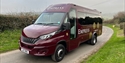 Burgundy Empress Coach vehicle (colour: burgundy) pictured on country road