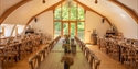 Oastbrook Vineyard tasting barn with long banquet tables and views across the surrounding countryside.