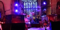 Stage set with drums, keyboards and lighting inside a historic venue at Rye Jazz Festival.