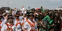 Traditional dancers and crowds celebrating during the Hastings Jack in the Green festival along the seafront.