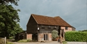 Historic barn at Oxney Organic Estate, home to the vineyard's tasting and visitor experience.