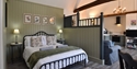 Stylish open-plan holiday cottage bedroom and living space at Rye & Beyond Holiday Cottages.