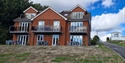 Modern holiday apartments at Rocklands Holiday Park with private balconies and outdoor seating.