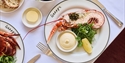 Fresh lobster served at The Gallivant restaurant with salad, lemon, bread and homemade sauce.