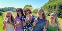 Guests enjoying a Vine & Country Tours wine tasting experience in the Sussex countryside vineyard.