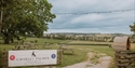 Entrance to Charles Palmer Vineyards overlooking rolling Sussex vineyards, picnic tables and countryside views.