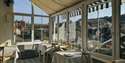 Breakfast room at The Laindons with bright bay windows, table settings and views across Hastings rooftops