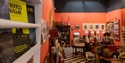 View through a book display into Tadhg Mae Projects, showcasing art, books and unique gifts in Hastings.