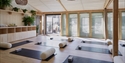 Light-filled yoga studio at The Gallivant with mats, bolsters and calming natural interiors.
