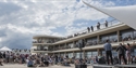 Exterior shot of the De La Warr Pavilion with large audience listening to music on the bandstand in Bexhill East Sussex
