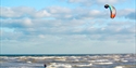 Kite surfer in the sea at Camber Sands, East Sussex