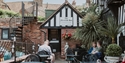 Courtyard seating at The Mermaid Inn in Rye, surrounded by historic brick and timber-framed buildings.