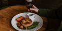 Home Made pub meal with pie, vegetables and gravy served at The Albion in Hastings, with a pint of beer.