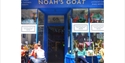 Exterior of Noah’s Goat wine shop and bar in Hastings, with outdoor seating and customers enjoying drinks.