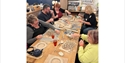 Made By Me pottery workshop in Pevensey, with participants creating clay crafts around a shared table.