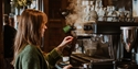 Barista making coffee at an espresso machine inside The Albion pub in Hastings.