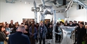 Crowd gathered around silver inflatable sculpture at Flatland Projects gallery opening in Bexhill.