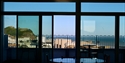 Interior view from Bunka Rooftop showing Hastings seafront, pier and castle through large windows.
