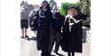 Costumed performers walk through Pevensey street during Talking History event.