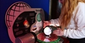Child interacts with a seasons exhibit at The Observatory Science Centre, exploring Earth’s orbit and changing seasons.