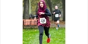 Image shows a person running in a nice work event on grass, the image is an action shot mid-run.