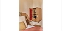 Image shows the inside of one of the bedrooms at Crafted at Powdermills, zoomed in on the wall next to the bed showing an open cupboard that is on the