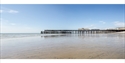 Hastings Pier at low tide viewed from the beach on the eastern side