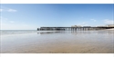 Hastings Pier at low tide viewed from the beach on the eastern side