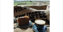 coffee and cake on a coffee bean sack, overlooking rye harbour nature reserve.