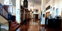 lobby with shiny parquet flooring and stairs to the left up to circle and bar.