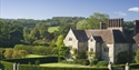 Bateman’s house and gardens in East Sussex, with historic stone façades and neatly clipped lawns.