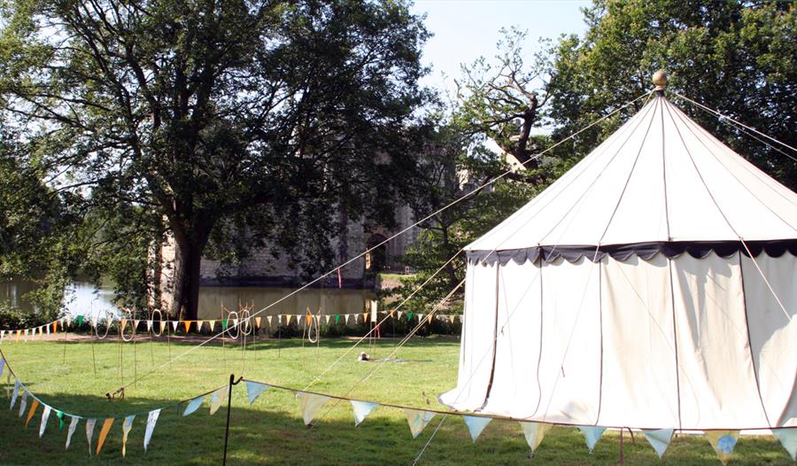bunting and white tent in field