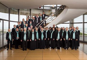 choir group standing by the spiral staircase of the de la warr pavilion.