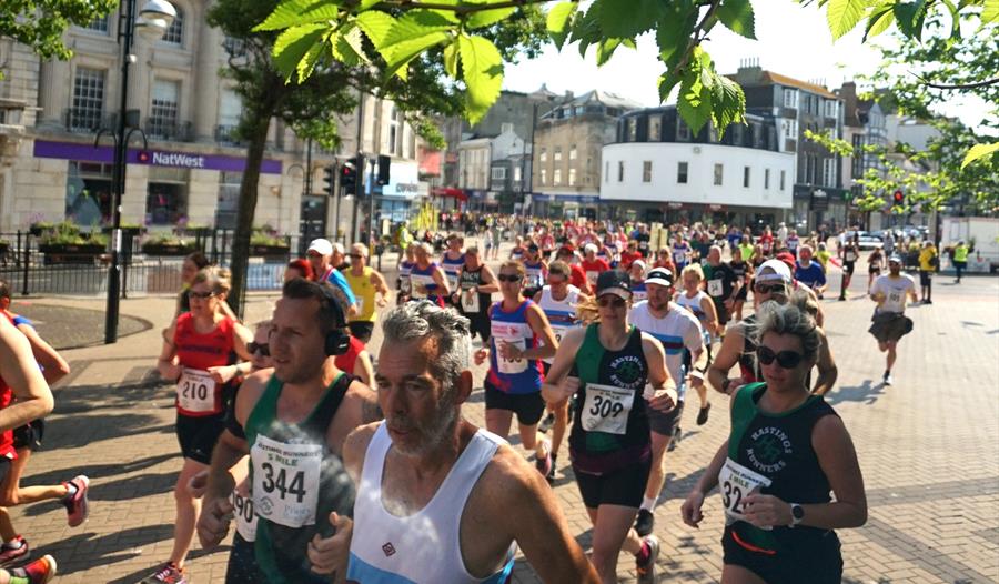 photograph of large group of runners in Hastings town centre.