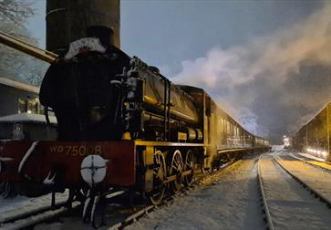 front of steam train on frosty ground