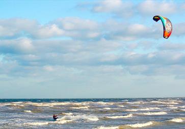 Kite surfer in the sea at Camber Sands, East Sussex
