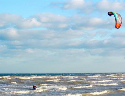 Kite surfer in the sea at Camber Sands, East Sussex