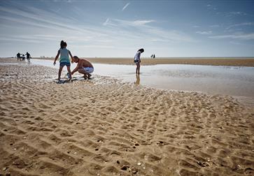 Children playing at low tide on Camber Sands