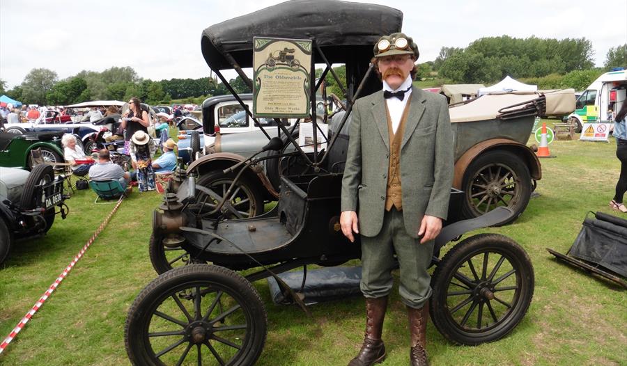 vintage early 20th century car and man in Edwardian style suit.