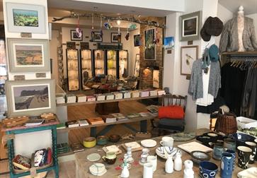 Interior shot at Greenfinch shop in Ticehurst, East Sussex, showing paintings, ceramics, clothes and gifts