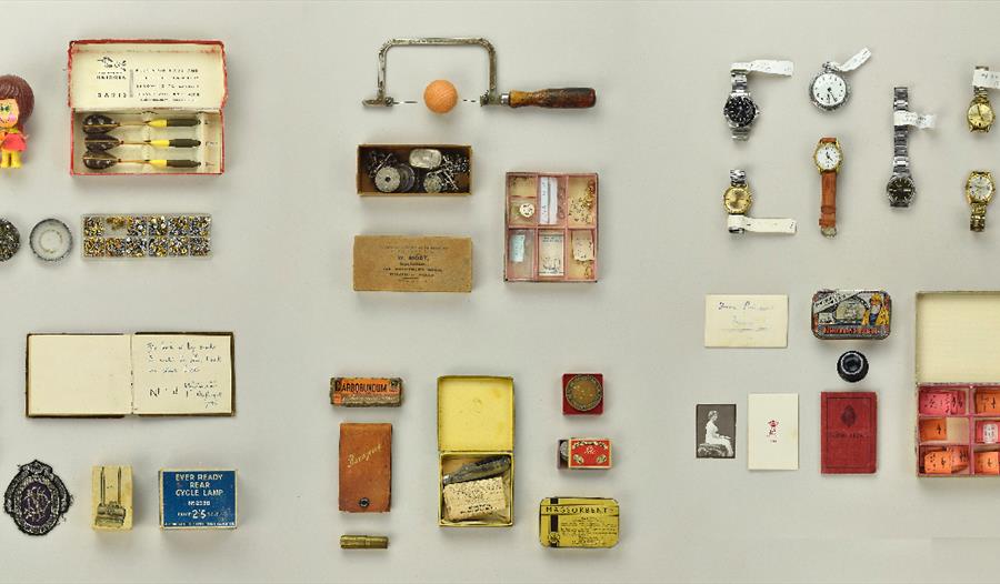 A collection of objects and memorabilia, laid out in block formation.