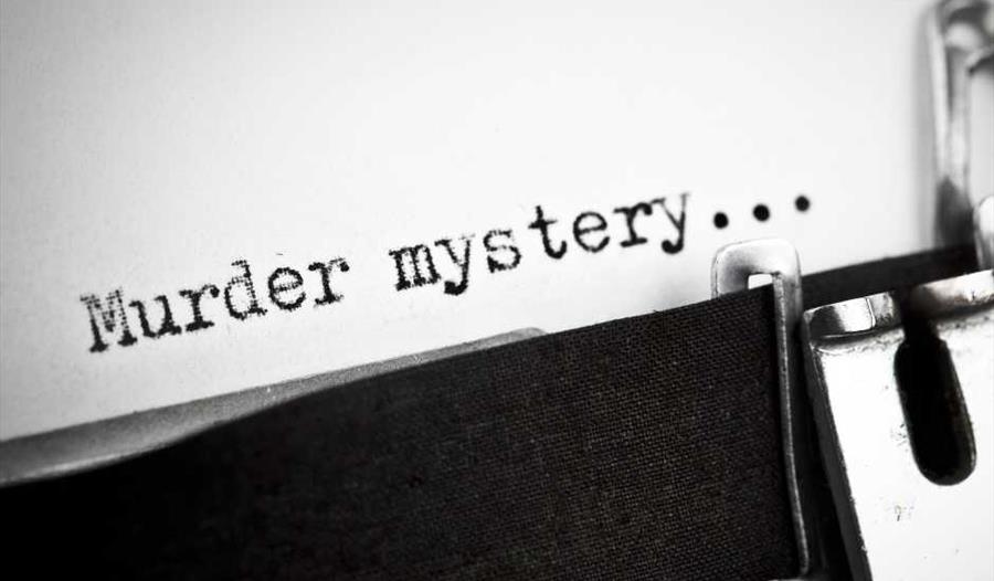 typewriter with text saying 'murder mystery'..
