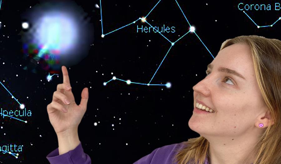 girl pointing to illustrated solar system.