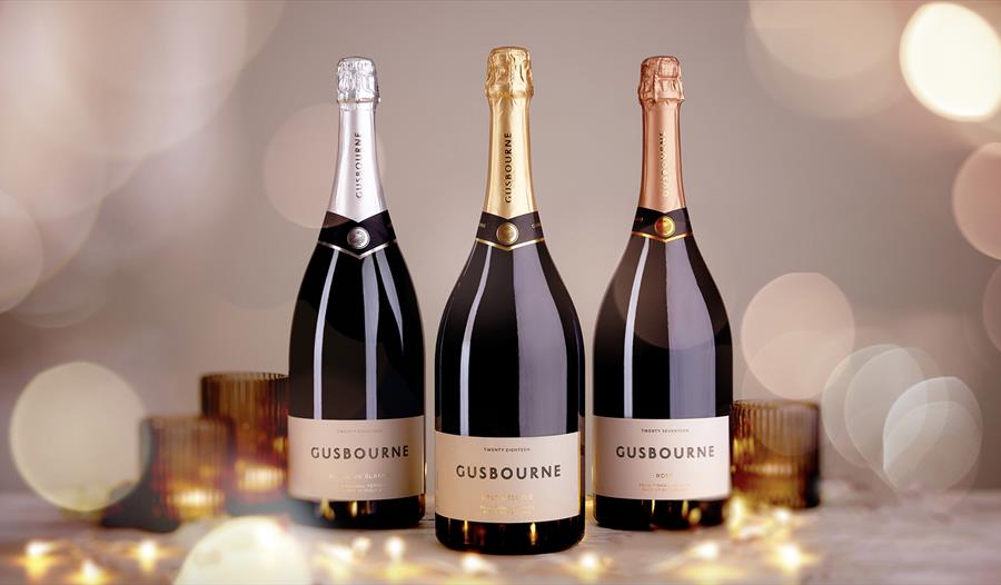 Photograph of three champagne bottles with bokeh effect.