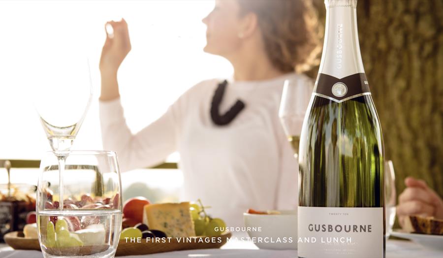 photo showing Gusbourne wine bottle on an al fesco table.