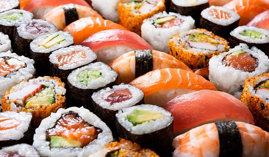 A photograph of sushi lined up.
