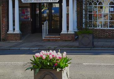 photo shows entrance to Battle Memorial Hall and display of tulips