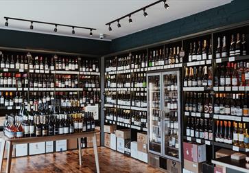 interior of wine show with shelves full of bottles