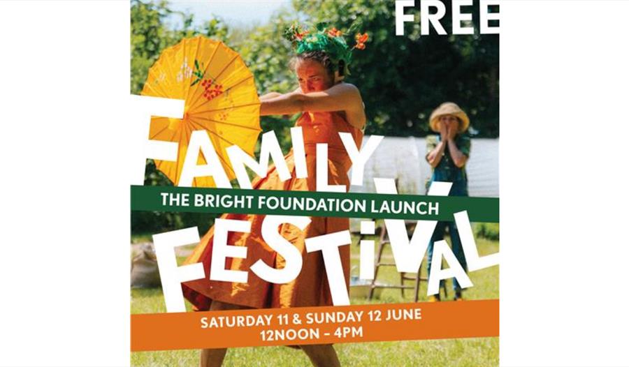 poster shows girl in orange dress holiding out paper umbrella. free family festival written on top