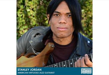 poster for stanley jordan concert, man with dark hair and leather jacket holds guitar